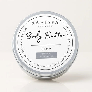 SaFiSpa Hibiscus Body Butter in silver tin, made with cocoa butter, shea butter, and jojoba oil, labeled silky and nourishing for dry to very dry skin.