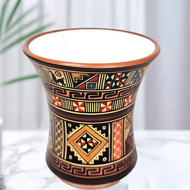 Ceramic candle vase with geometric patterns on a white background