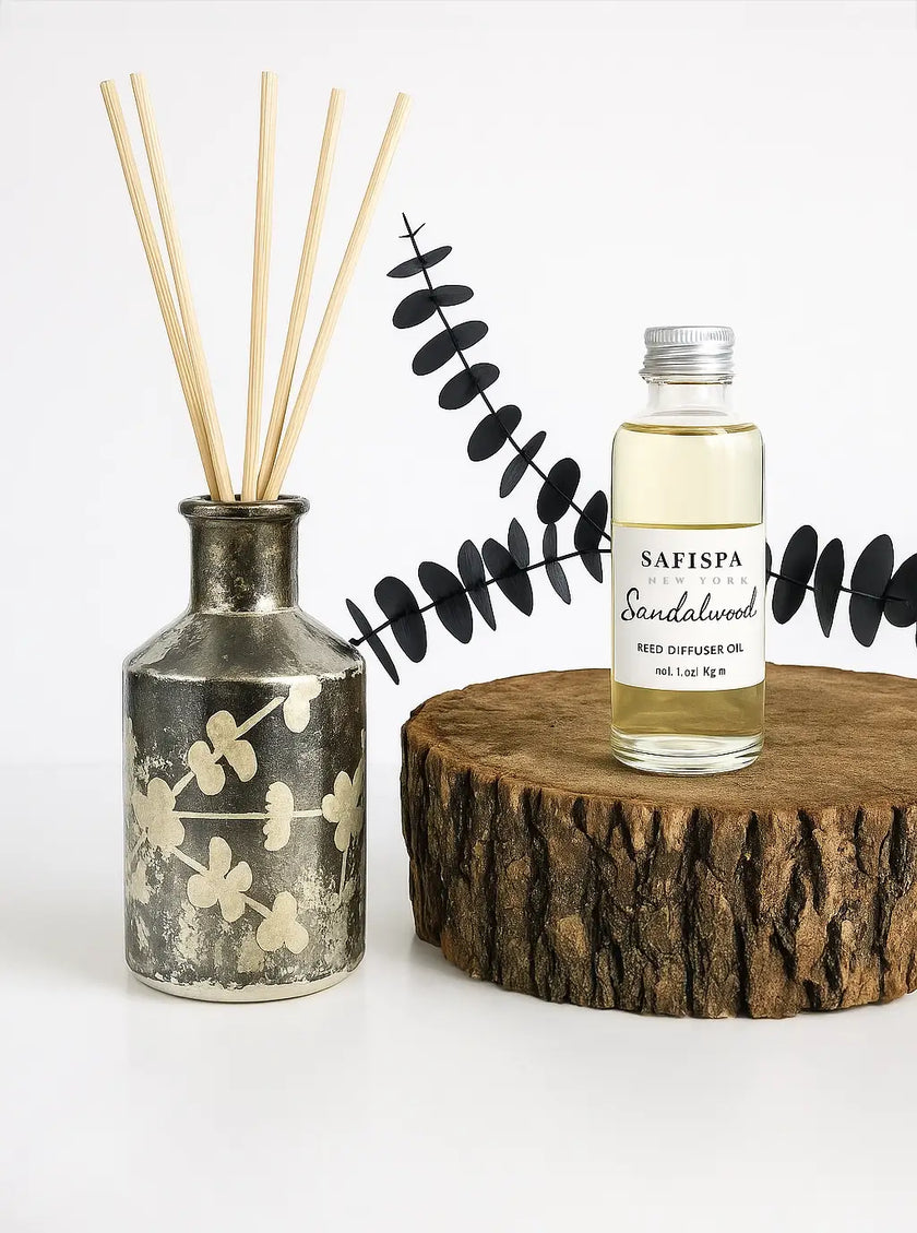 Sandalwood diffuser set with decorative sticks and leaf design on a white background