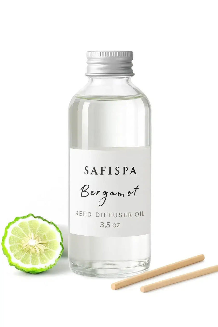 Safispa Bergamot reed diffuser oil bottle with lime and wooden sticks on a white background