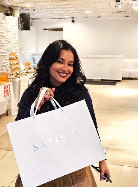 Customer holding SaFiSpa soy candle during evening self-care ritual