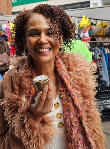 Customer showcasing SaFiSpa’s handmade candle in reusable glass jar