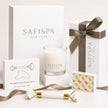 Luxury candle gift set by SaFiSpa New York featuring a premium soy candle, facial massage roller, gua sha stone, handmade soap flowers, elegant white gift boxes, and luxury spa accessories for self-care, birthdays, weddings, anniversaries, Mother's Day, and thoughtful gifting.