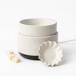 White ceramic electric waxt melt diffuser with a black base on a white background