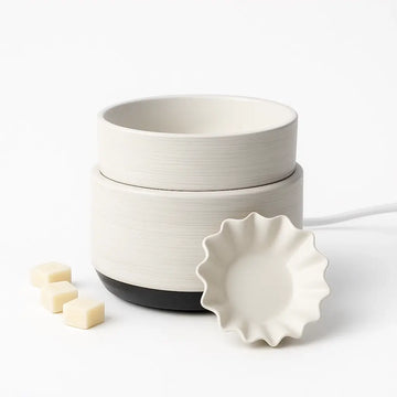 White ceramic electric waxt melt diffuser with a black base on a white background