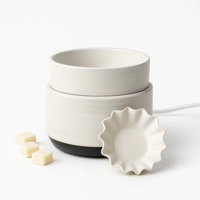 White ceramic electric waxt melt diffuser with a black base on a white background