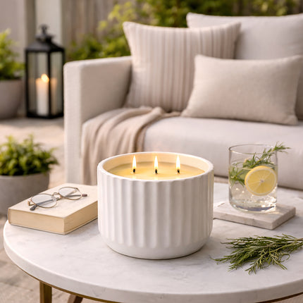 luxury citronella candle on outdoor patio table with lemon and herbs creating a relaxing mosquito repellent atmosphere
