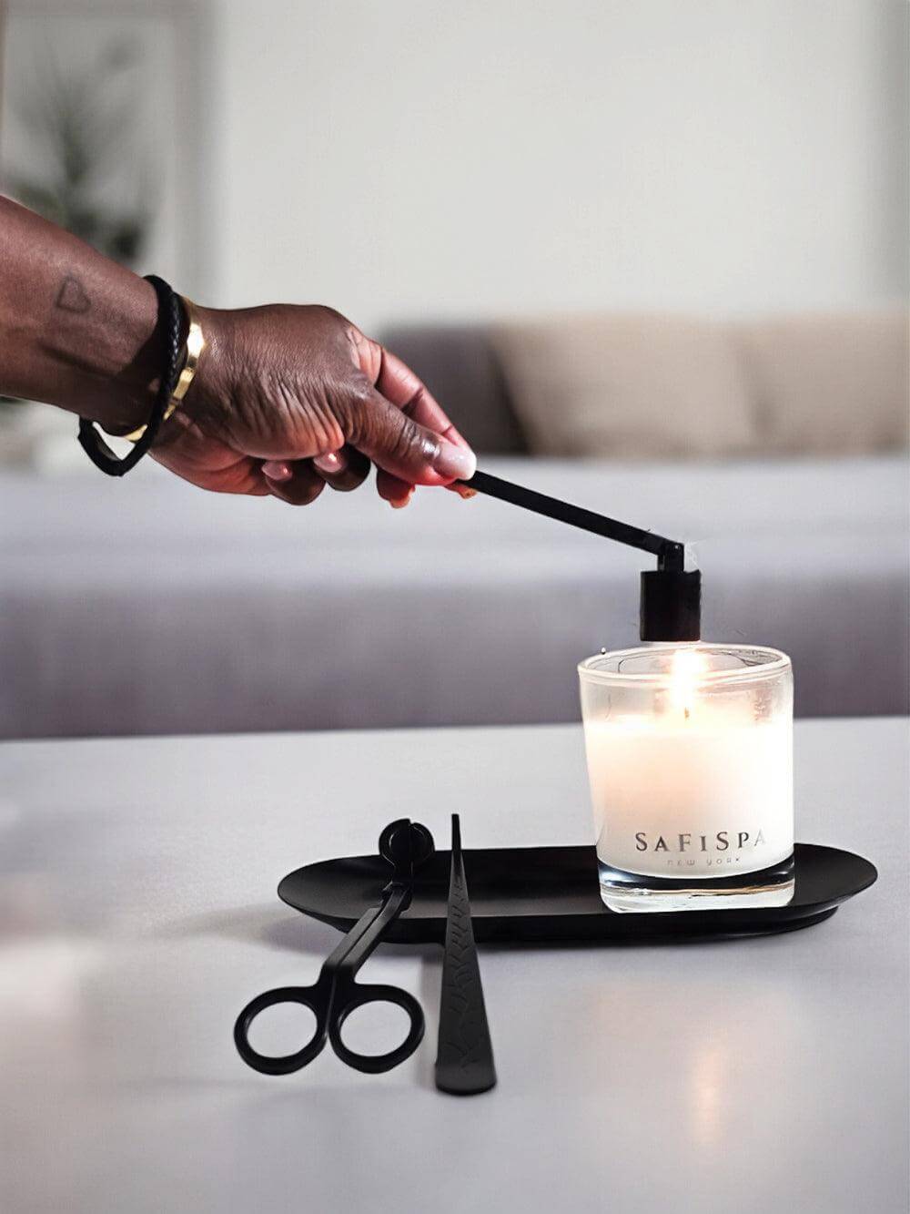 Bell-shaped flame snuffer for safe and smokeless candle extinguishing.