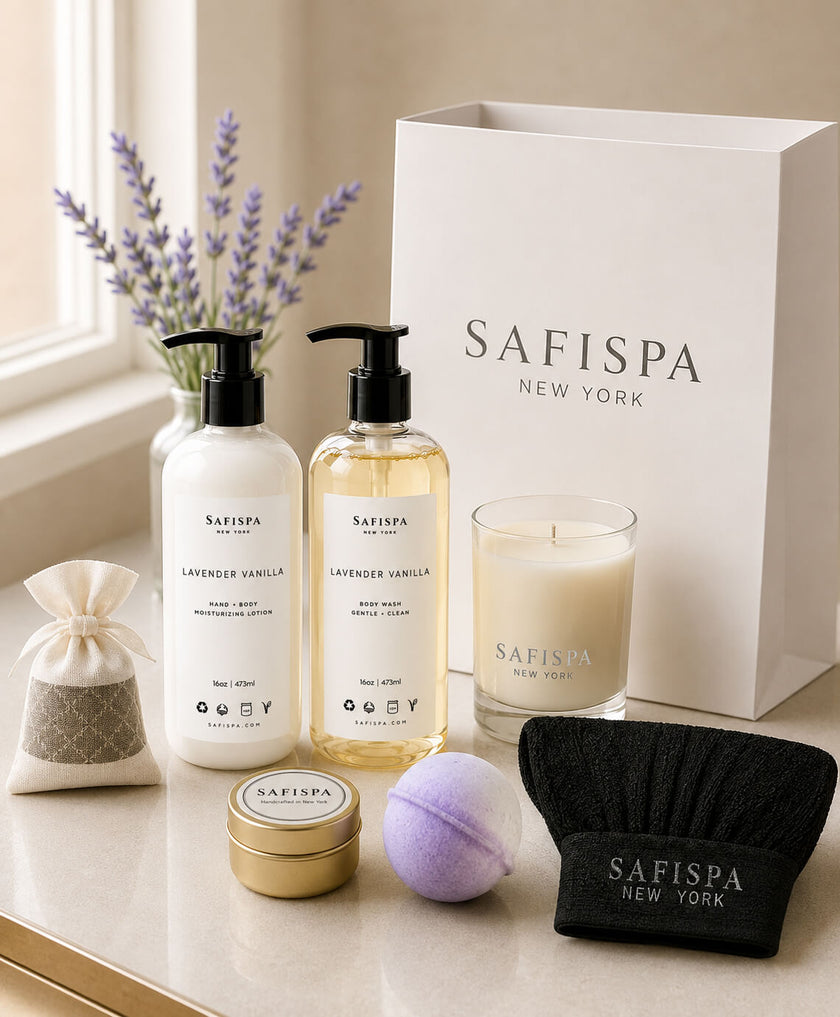 SaFiSpa Lavender Vanilla luxury spa gift set featuring a hand and body lotion, body wash, soy candle, lavender sachet, bath bomb, mini travel candle, exfoliating glove, and premium white gift bag handcrafted in New York.