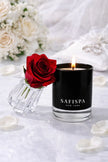 Safispa candle with a red rose on a white surface
