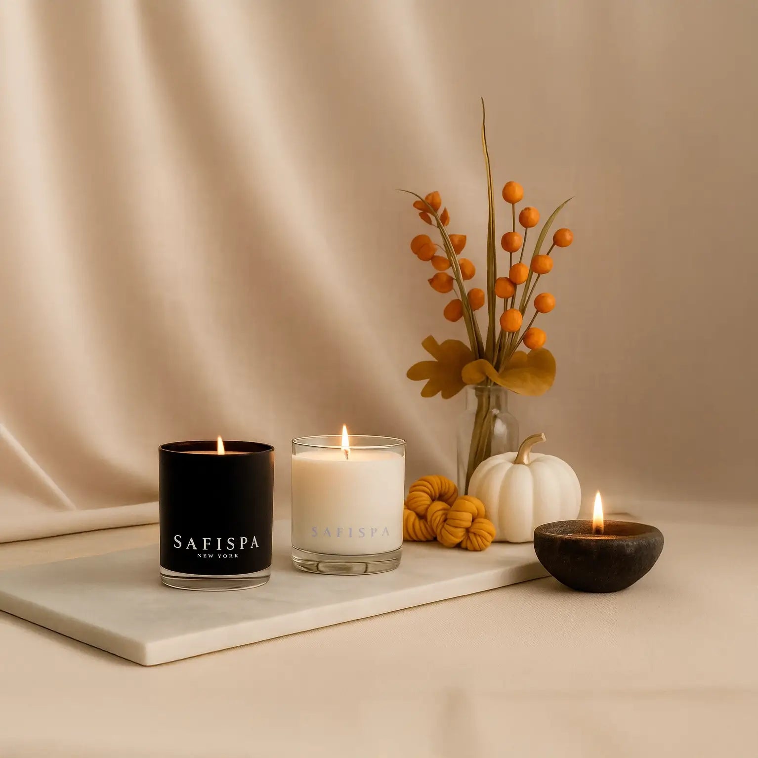 SaFiSpa luxury scented candles with autumn decor, hand-poured soy candles in black and white jars, perfect for cozy home fragrance and fall ambiance.
