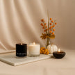 SaFiSpa luxury scented candles with autumn decor, hand-poured soy candles in black and white jars, perfect for cozy home fragrance and fall ambiance.