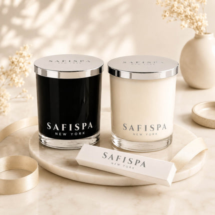 SaFiSpa luxury soy candle collection featuring handcrafted black and white candles with silver lids and premium gift packaging on a marble display