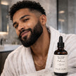 man with healthy shiny beard using SAFISPA Tobacco and Spice nourishing beard oil in luxury bathroom