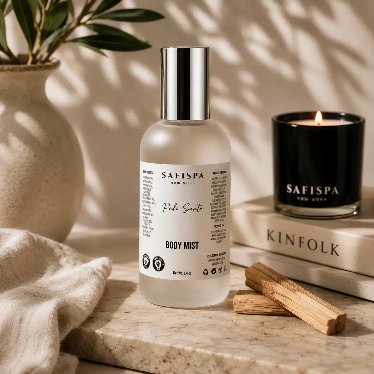 SaFiSpa Palo Santo body mist with Palo Santo wood and luxury scented candle in a warm self-care setting