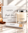 SaFiSpa New York Pumpkin Spice scented soy candle in a clear glass jar with silver lid, displayed beside its luxury white gift box, cinnamon sticks and matches
