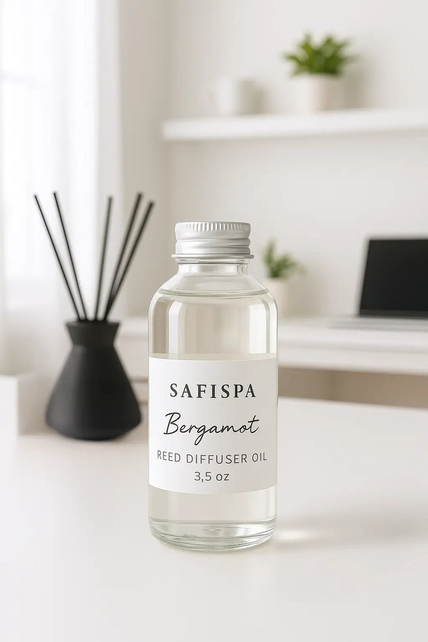 Bottle of SAFISPA Bergamot reed diffuser oil on a white surface with a blurred background