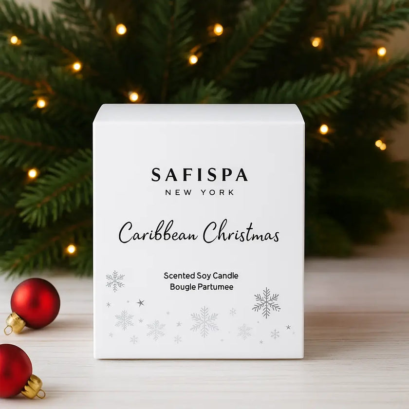 Elegant SaFiSpa Christmas scented candle glowing in premium glass jar with holiday greenery and ornaments