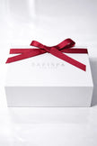 White gift box with a red ribbon and 'Safispa' branding on a white background