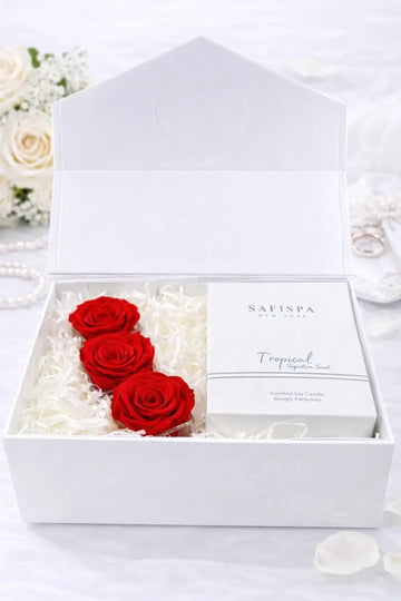 White box with red roses and a product inside, surrounded by white flowers.
