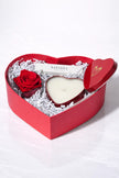 Heart-shaped gift box with a red rose and white candle, branded 'Safispa', on a white background.