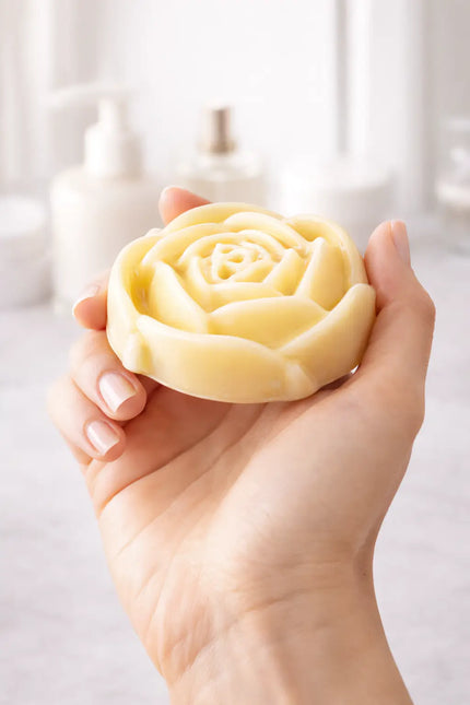 Solid lotion bar moisturizer by SaFiSpa shown in hand for easy daily body care