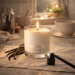 SaFiSpa Vanilla Essence candle glowing in luxury living room creating warm relaxing vanilla home fragrance.