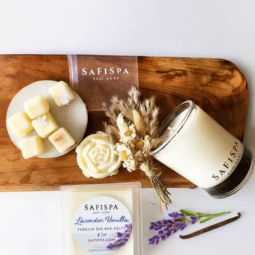Safispa candles and wax melts on a wooden tray with lavender and vanilla packaging.