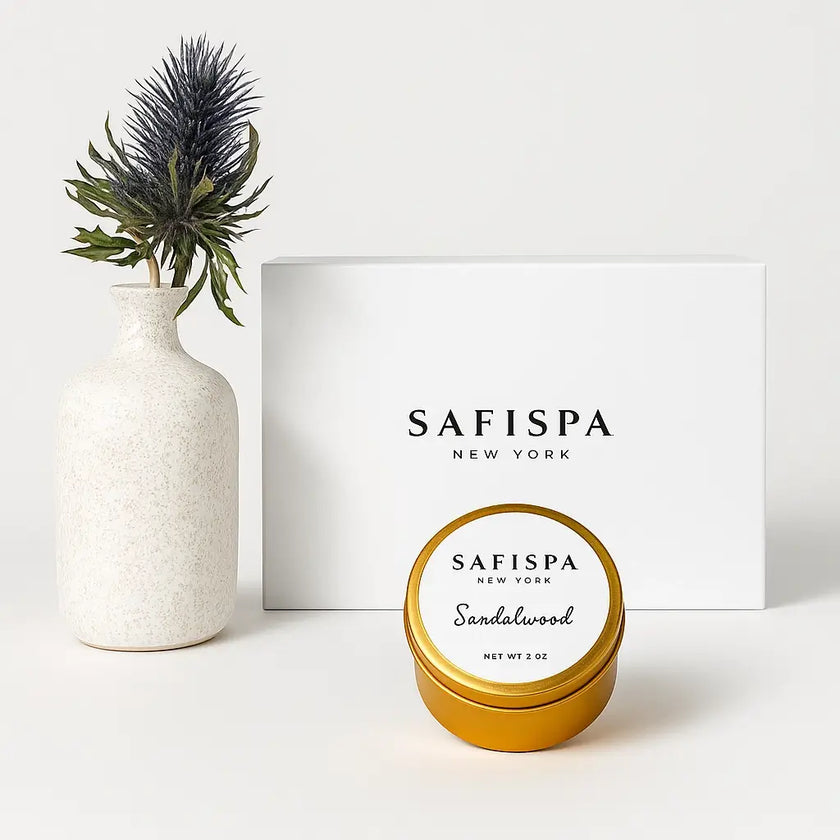 Gold tin labeled 'Safispa New York' with a white vase and plant on a light background