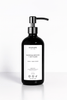 Sandalwood + Vetiver Hand and Body Moisturizing Body Wash in black pump bottles with stainless steel tops, set against a golden marble background for an elegant presentation.