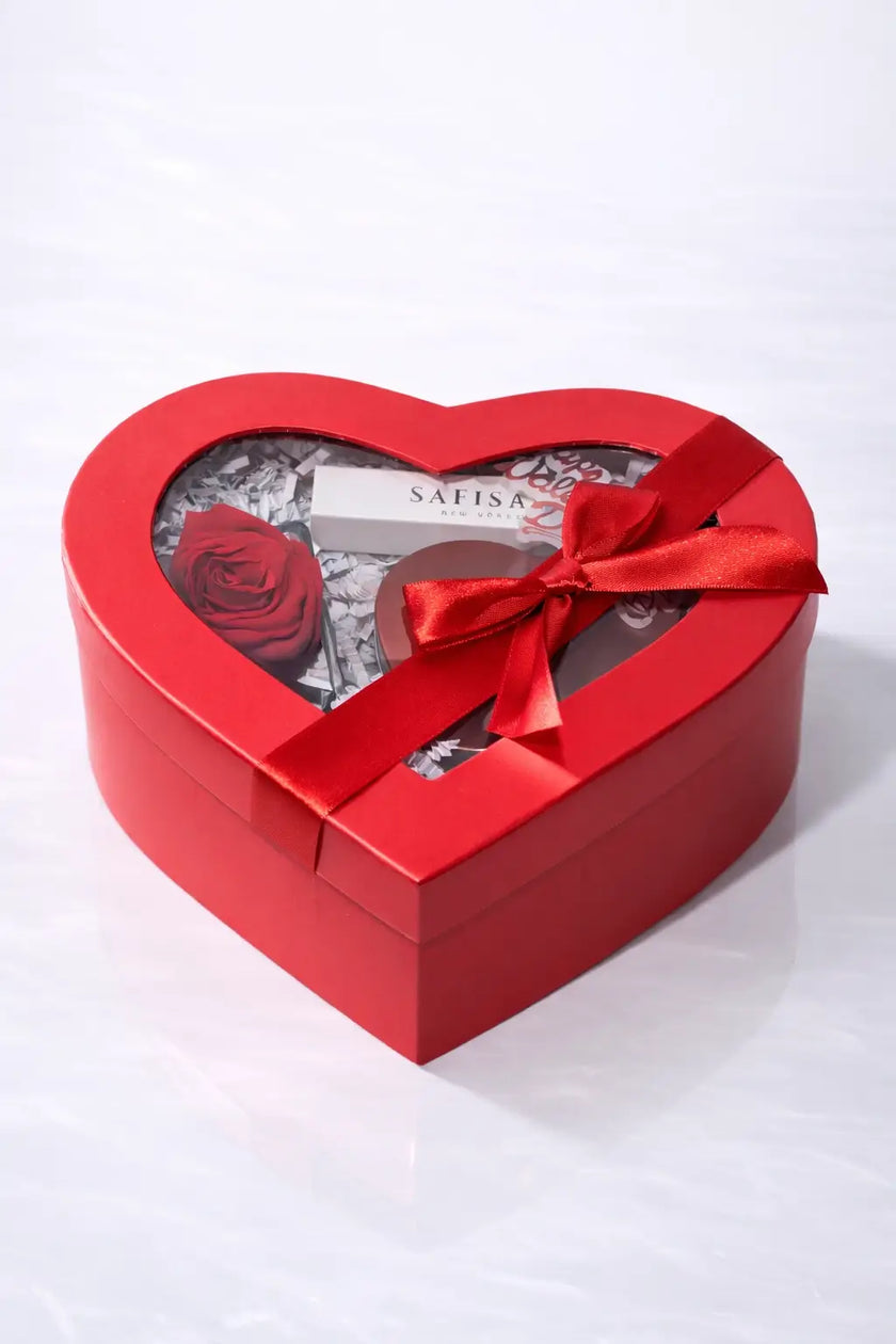 Heart-shaped red gift box with a bow on a white background