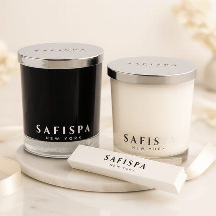 Two candles and match box with 'SAFISPA' branding on a light background.