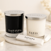 Two candles and match box with 'SAFISPA' branding on a light background.