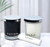 Two candles and match box with 'SAFISPA' branding on a light background.
